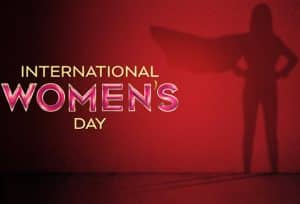 一个女英雄的形象在红色背景上的国际妇女节在闪闪发光的信件